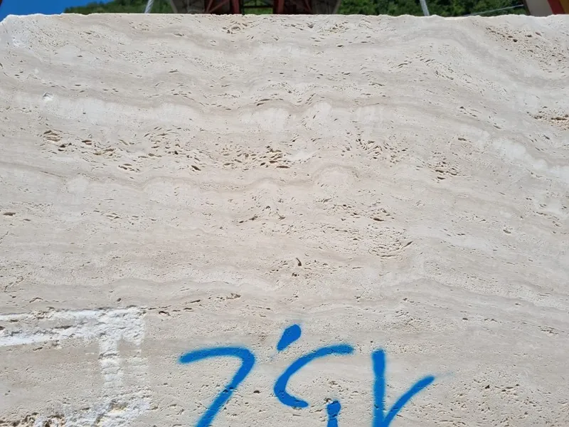 Slab of beige Navona travertine: light beige background with fine, faint horizontal bands (another slab)