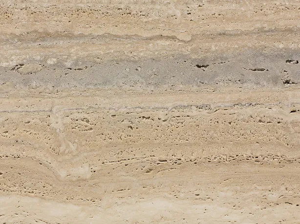 Close-up of beige Striato travertine: aligned pores and fine beige and gray stripes
