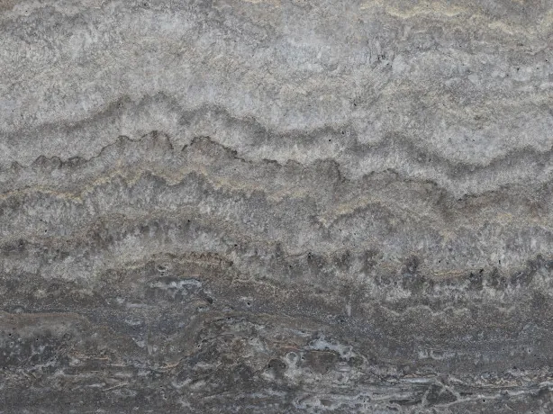 Close-up of gray Titanium travertine: dense light and dark gray bands with beige touches