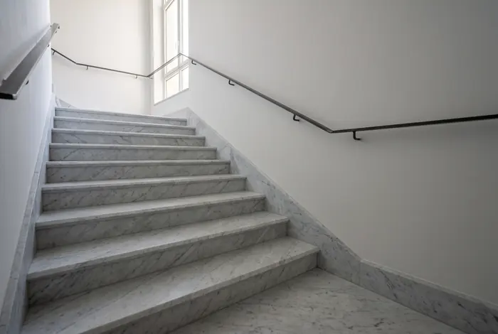 Carrara marble staircase with a landing