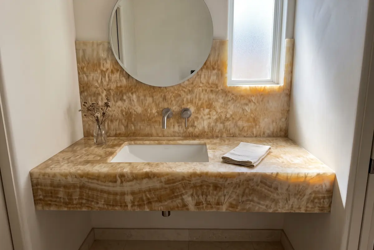 Bathroom vanity with a honey onyx countertop and backsplash