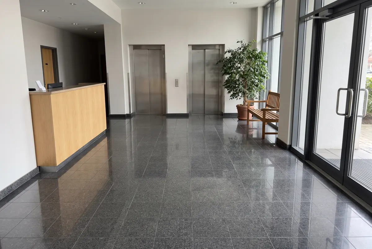 Building lobby with a polished dark gray granite floor